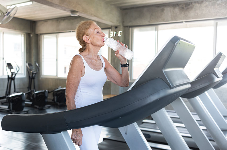 Senior woman staying hydrated during a workout